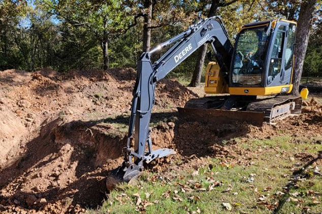 Photo of an excavator digging in a NWA property